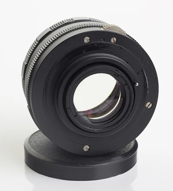 A camera lens with its glass elements visible.