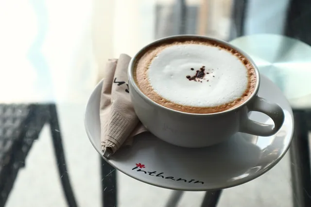 A cup of cappuccino with milk foam.