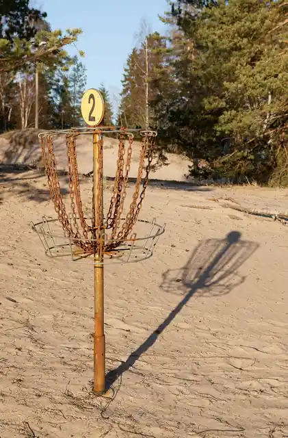 A disc golf basket on an outdoor course.