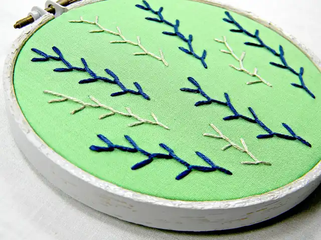 Fabric held in an embroidery hoop.
