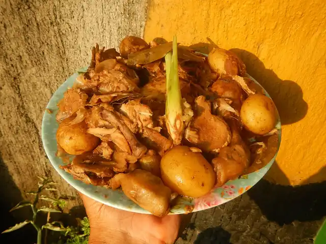 Chicken adobo served as part of a Filipino meal.