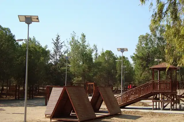 Timber play equipment in a wooded setting.