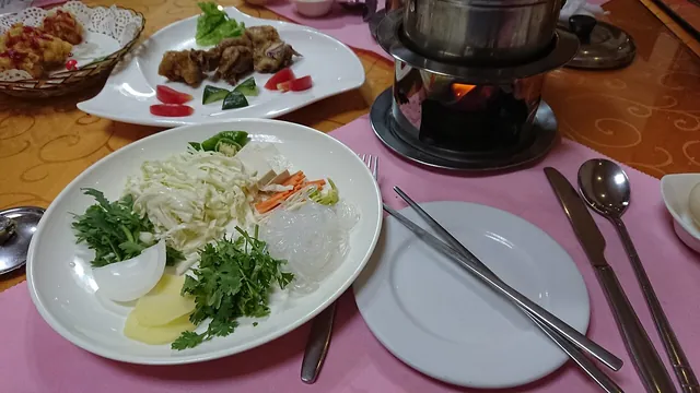 A hot-pot meal with ingredients for the table.