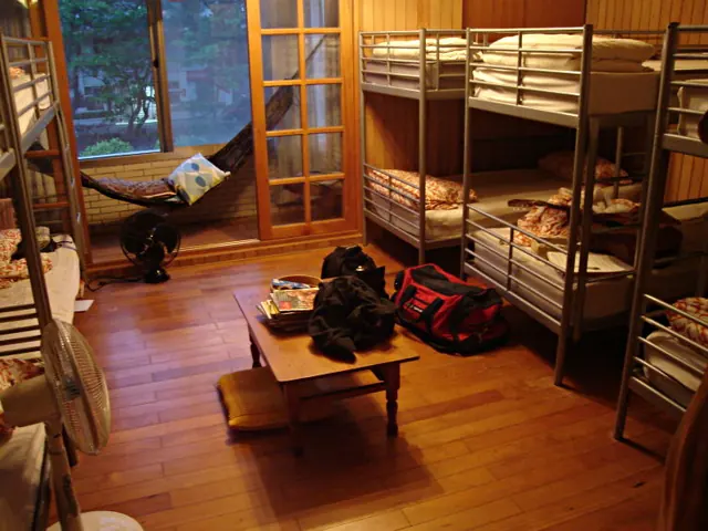 Bunk beds and a low table in a shared hostel room.