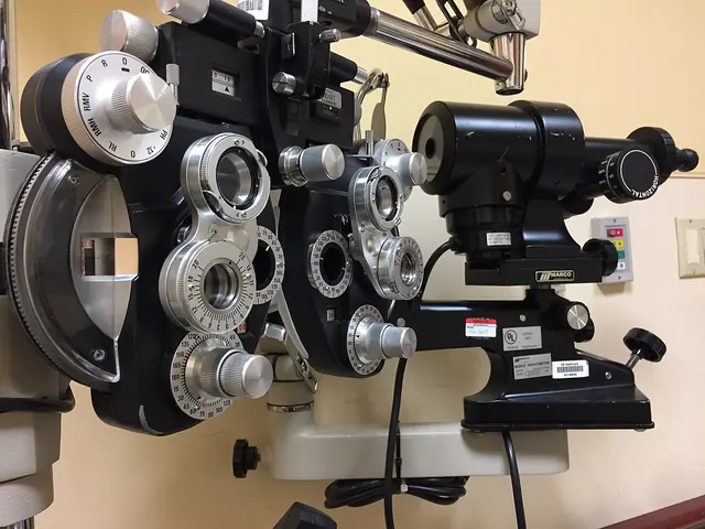 A phoropter and other eye-examination equipment in an optometry room.