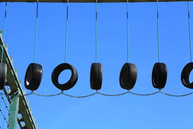 Suspended tyres form an obstacle on an outdoor ropes course.