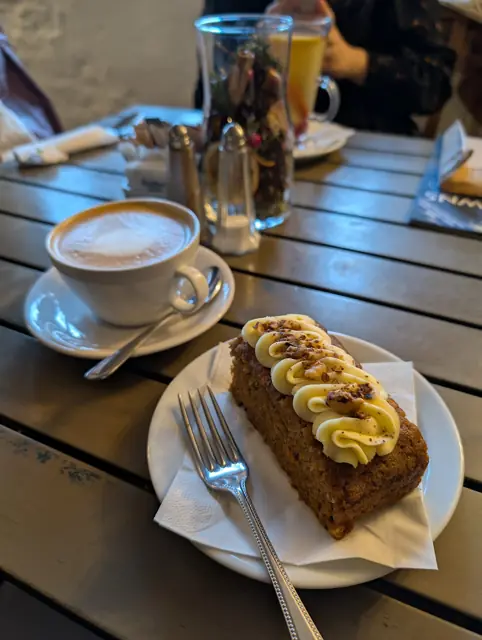 Carrot cake served with a cup of coffee.