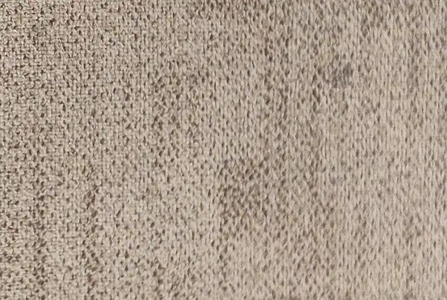 A close view of a beige woven carpet surface.
