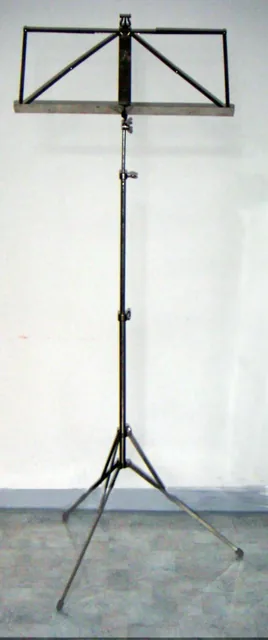 A metal music stand with an adjustable frame.