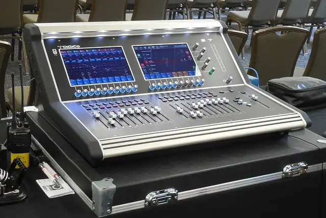 Faders and controls on an audio mixing console.