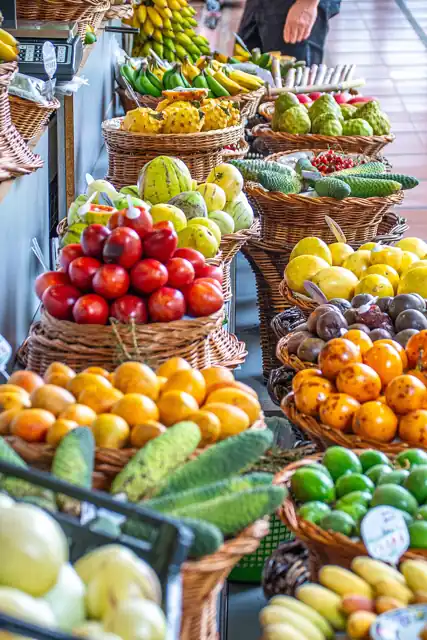 Colourful fresh fruit displayed in baskets at a market.