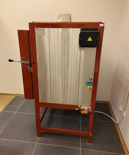 A freestanding electric pottery kiln with its front-loading door closed.