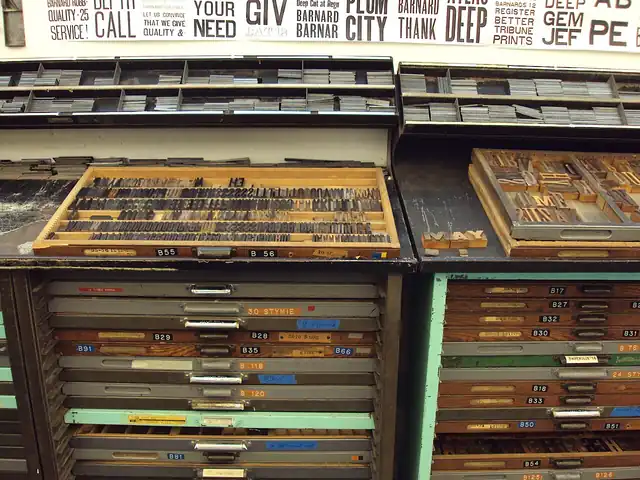 Cases of metal and wooden type arranged in a letterpress studio.