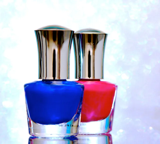 Two bottles of blue and pink nail polish.