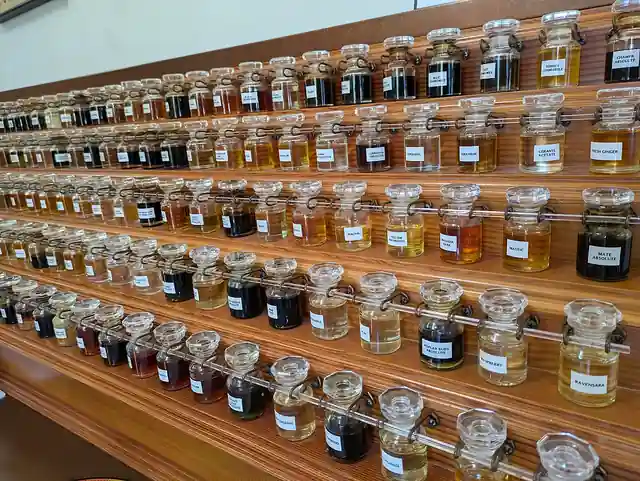 Rows of labelled glass scent bottles arranged on a perfume organ.