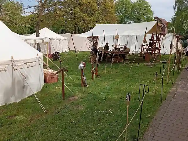 Canvas tents, camp equipment and wooden furniture at a historical re-enactment camp.