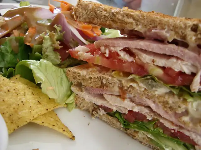A club sandwich cut into triangular sections.