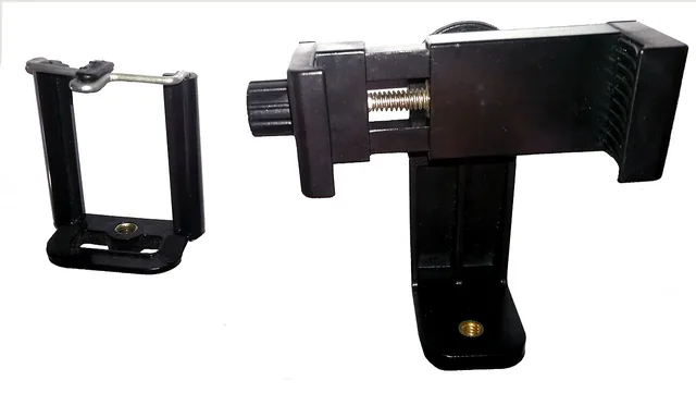 Two adjustable holders for mounting a smartphone on a tripod.
