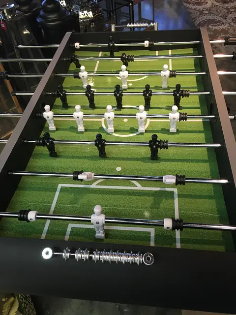 Rows of black and white players on a table football game.
