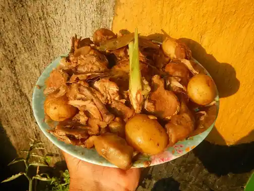 Chicken adobo served as part of a Filipino meal.