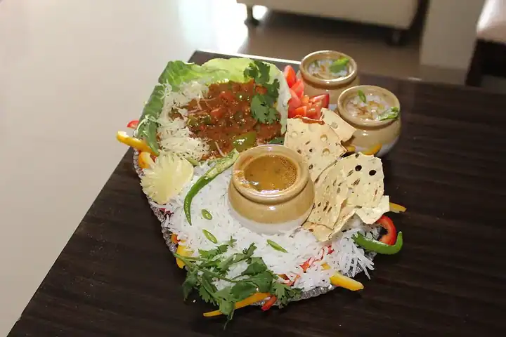 A mixed vegetable meal with rice and accompaniments.
