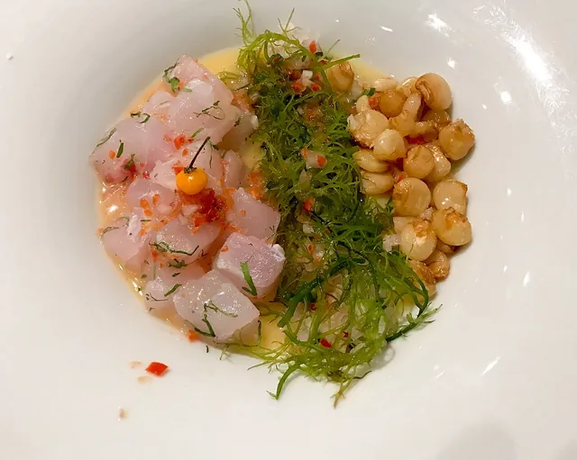 A plate of ceviche with fresh accompaniments.