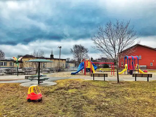 An outdoor playground with climbing and play equipment.