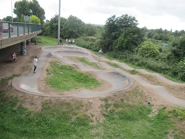 A looping pump track with rollers and banked turns.