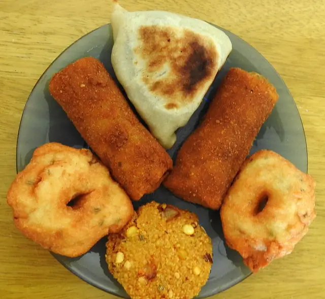 A selection of Sri Lankan savoury snacks on a plate.